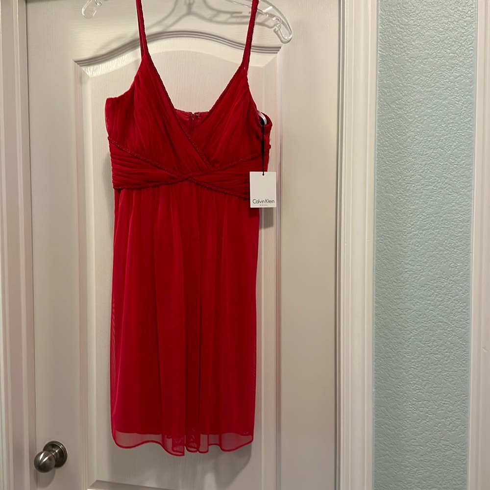 Watermelon pink dress with cute straps and in perfect condition with tags.